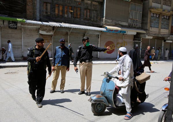 Police officers enforced shutdown restrictions in Peshawar, Pakistan, on Tuesday.